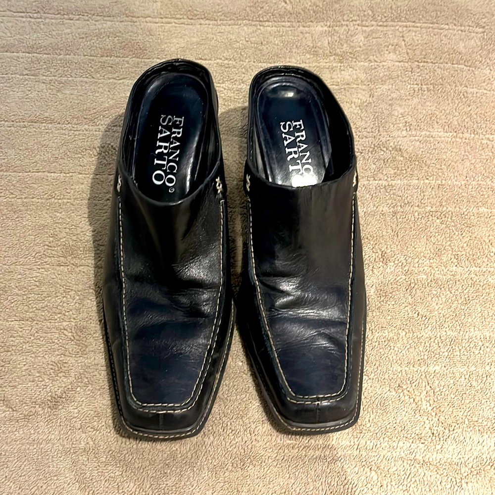 Heeled size 8 black leather mules.